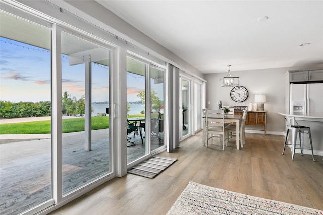 interior space with a notable chandelier and light wood-type flooring