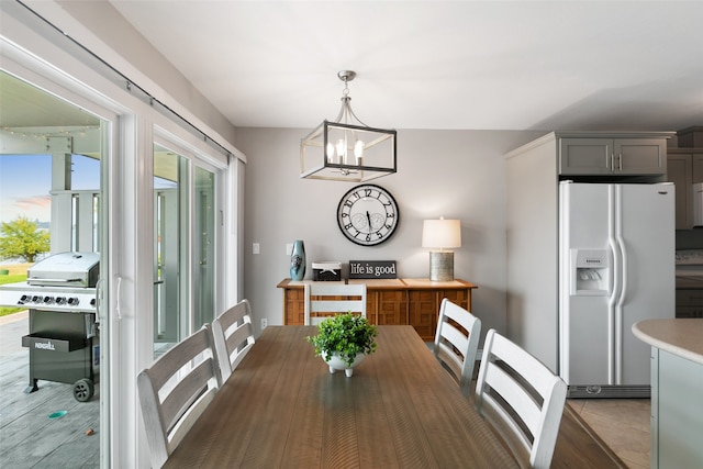 tiled dining area featuring a notable chandelier