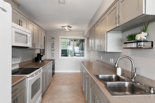 kitchen featuring gray cabinets, white appliances, sink, and light tile floors