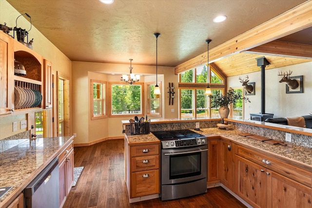 kitchen featuring a wood stove, stainless steel appliances, beamed ceiling, a chandelier, and pendant lighting