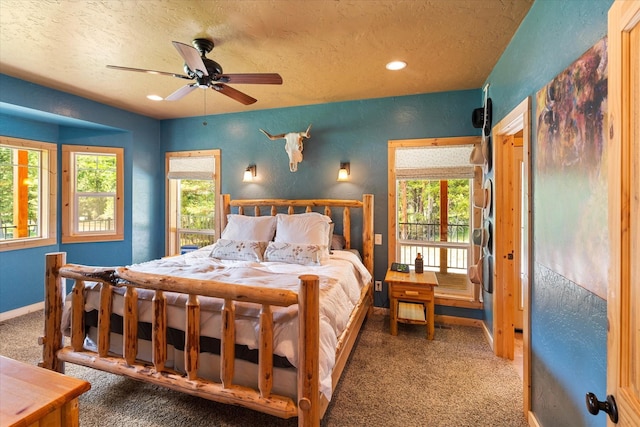 bedroom featuring ceiling fan, carpet, and a textured ceiling