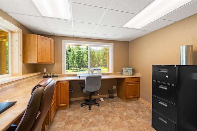 office area with a paneled ceiling