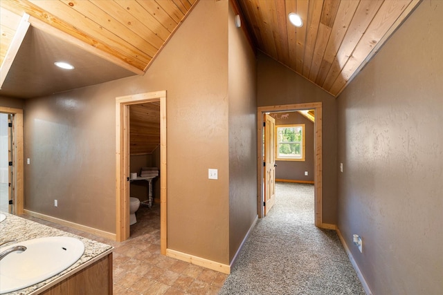 bathroom featuring vanity, toilet, wooden ceiling, and vaulted ceiling