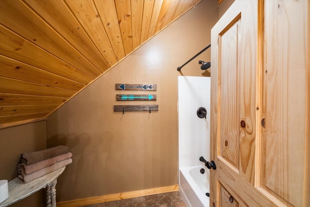 bathroom with wood ceiling, lofted ceiling, and tub / shower combination