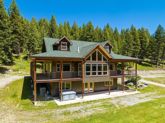 back of property with a lawn, a patio area, central AC unit, and a deck