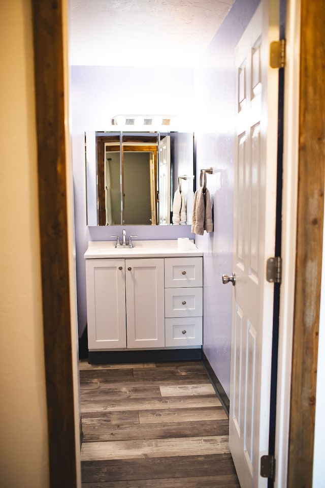 bathroom featuring vanity and hardwood / wood-style flooring