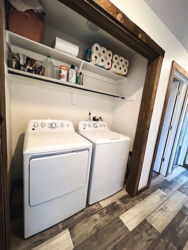 clothes washing area featuring separate washer and dryer and dark wood-type flooring