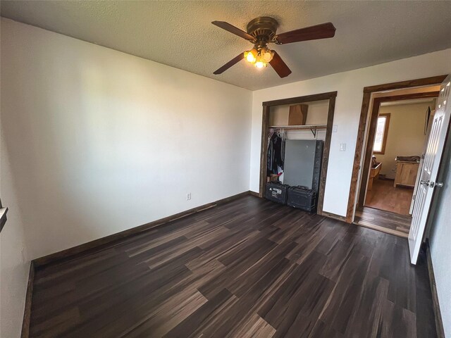 405 S Cherry St, Townsend, MT 59644 - unfurnished bedroom featuring dark wood-type flooring, a closet, and ceiling fan