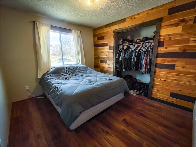 405 S Cherry St, Townsend, MT 59644 - bedroom featuring a textured ceiling, wooden walls, a closet, and wood finished floors