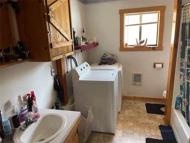 laundry area with light tile flooring, sink, and washing machine and dryer