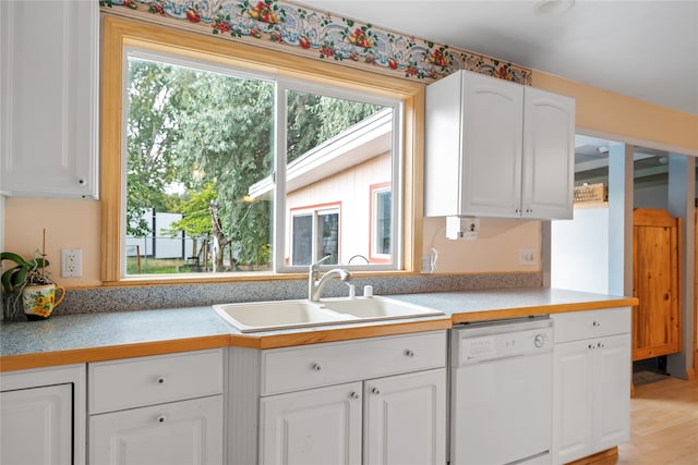 707 W Desta St, Hamilton, MT 59840 - kitchen featuring white cabinets, light wood-type flooring, dishwasher, and sink