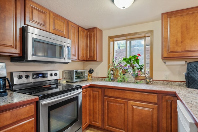 707 W Desta St, Hamilton, MT 59840 - kitchen featuring appliances with stainless steel finishes and light stone countertops