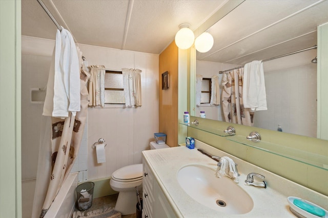 full bathroom featuring a textured ceiling, vanity, toilet, and shower / bath combo with shower curtain