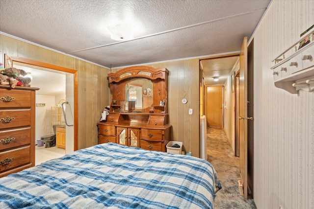 carpeted bedroom with ornamental molding, a textured ceiling, and wooden walls