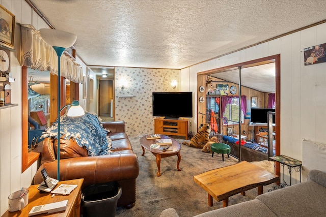 living room with crown molding, carpet floors, a textured ceiling, and wooden walls