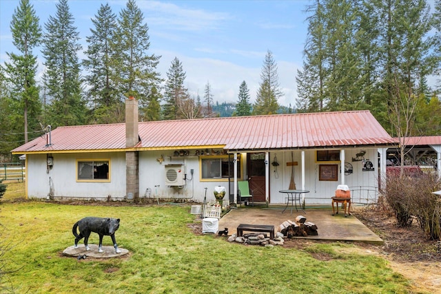 back of house featuring ac unit and a yard