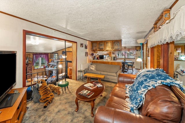 carpeted living room with a textured ceiling, crown molding, and wood walls