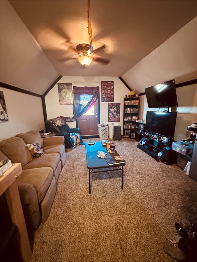 carpeted living room with radiator heating unit, ceiling fan, and vaulted ceiling