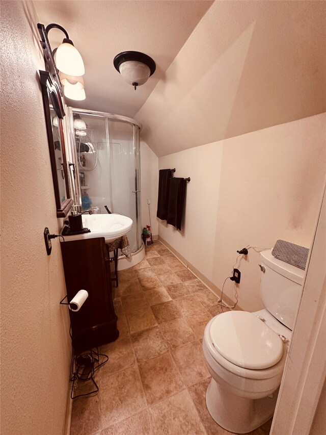 bathroom featuring lofted ceiling, tile floors, toilet, and vanity