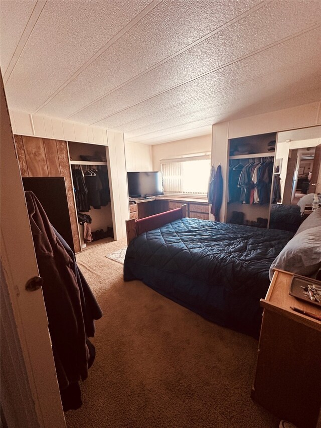 bedroom featuring dark carpet and a textured ceiling