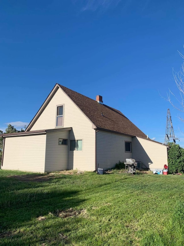 view of side of home featuring a lawn