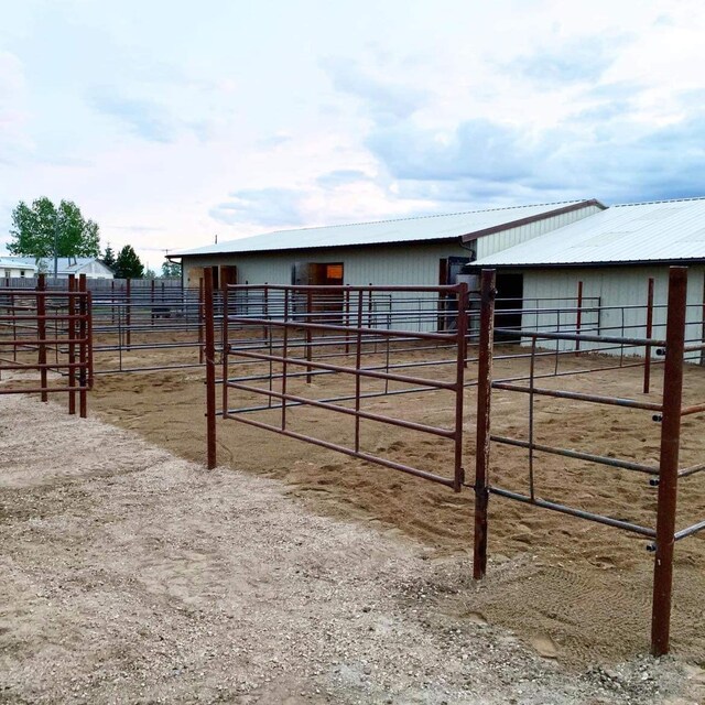 view of yard with a rural view and an outdoor structure