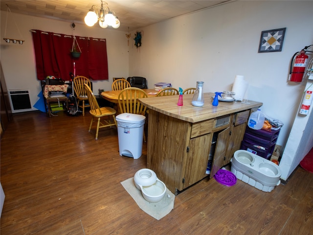 kitchen with a notable chandelier and dark wood-type flooring