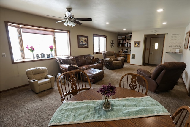 living room with ceiling fan and dark colored carpet