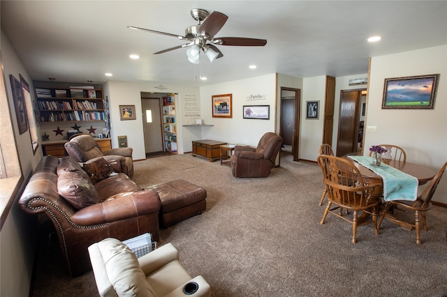 living room featuring ceiling fan and light colored carpet