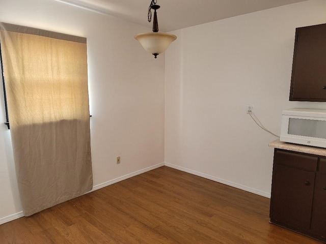 unfurnished dining area featuring hardwood / wood-style floors