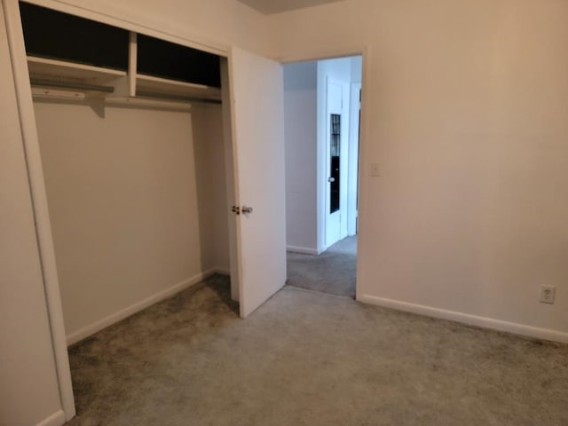 unfurnished bedroom with a closet and carpet