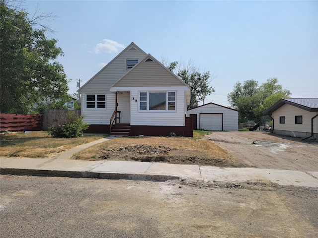 view of front facade featuring a garage and an outdoor structure