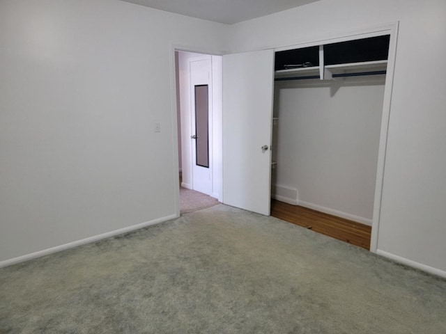 unfurnished bedroom with a closet and carpet flooring