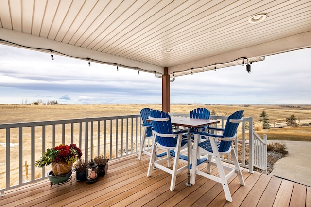 wooden deck with a rural view