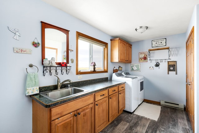 laundry room with cabinets, sink, dark hardwood / wood-style floors, washing machine and dryer, and a baseboard radiator