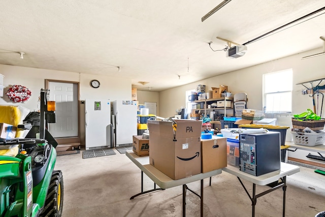 garage with white fridge and a garage door opener