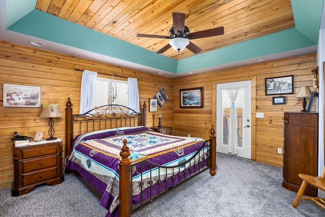 carpeted bedroom featuring a raised ceiling, ceiling fan, and wooden ceiling