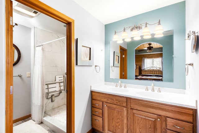 bathroom with curtained shower, ceiling fan, and vanity