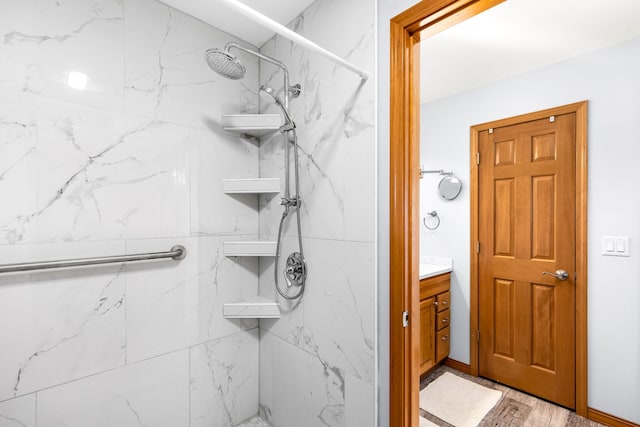 bathroom featuring vanity and tiled shower