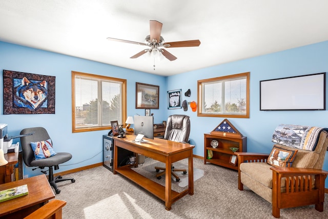 office area featuring light carpet and ceiling fan