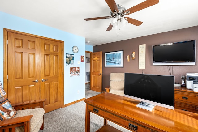 carpeted office featuring ceiling fan