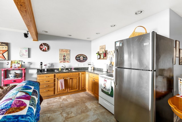 kitchen with beamed ceiling, range, stainless steel refrigerator, and sink