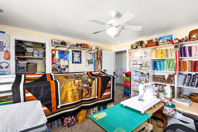 carpeted office featuring ceiling fan