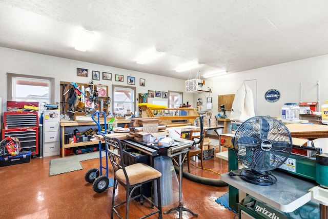 misc room featuring a textured ceiling and a workshop area