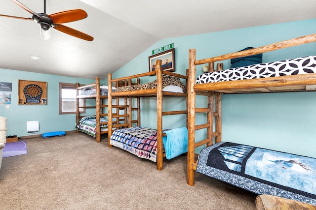 carpeted bedroom with vaulted ceiling and ceiling fan