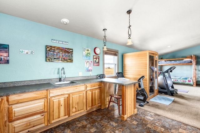 kitchen with kitchen peninsula, sink, and pendant lighting