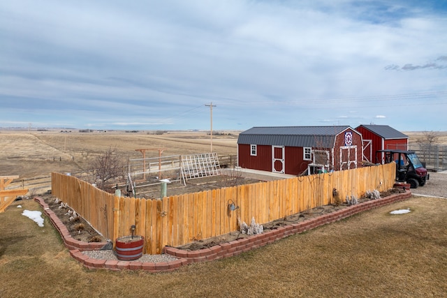 view of yard featuring a rural view and an outdoor structure