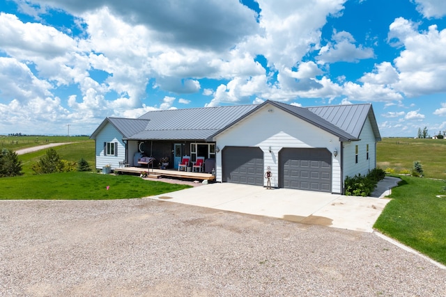 view of front of house with a front lawn, covered porch, and a garage