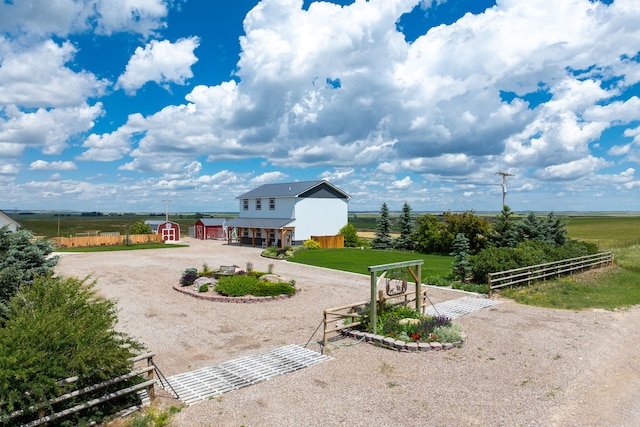 view of yard featuring a rural view and an outdoor structure