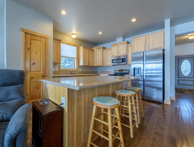 30 Demers Pl, Eureka, MT 59917 - kitchen featuring appliances with stainless steel finishes, light brown cabinetry, a center island, dark wood-style floors, and recessed lighting